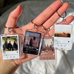 a person holding four different cell phones in their hands, each with an image on them