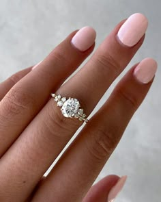 a woman's hand with a three stone ring on top of her left hand