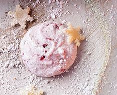 a cookie with powdered sugar and crumbs on it sitting on a table