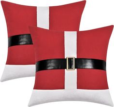 two red and white santa claus pillows with black leather belt on each pillow, one has a gold buckle