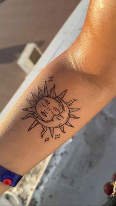 a person with a sun tattoo on their arm