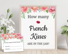 a sign that says how many french kisses are in the jar? next to some flowers