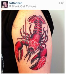 a man with a tattoo on his arm has a red lobster