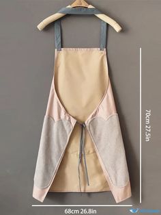 an apron hanging on a hanger with measurements for the front and back pockets,