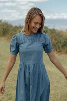 A beautiful soft denim dress with a smocked collar featureLENGTH: 46" Made In China Homestead Wardrobe, Cohesive Wardrobe, Farmhouse Wardrobe, Dresses Feminine, Neutral Capsule Wardrobe, Fashion Romantic, Maternity Wardrobe, Denim Midi Dress, Fall Sale