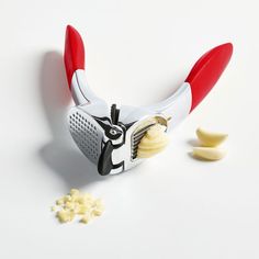 a close up of a banana peeler with some peeled bananas in front of it