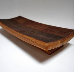 a wooden board sitting on top of a white table