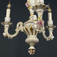 a white chandelier with pink flowers on it