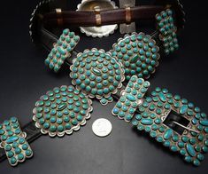 "VINTAGE TURQUOISE CLUSTER BELT DESCRIPTION: This spectacular belt features heavy gauge, hand-stamped sterling silver conchos and butterflies adorned with round snake eye specimens of natural turquoise. Circa 1950s, this museum quality belt will be a cherished addition to your collection of the very finest vintage Southwestern and Native American jewelry. MEASUREMENTS: Belt measures 40\" long x 7/8\" wide Belt is punched to fit from 33\" to 37\" Buckle measures 3 1/4\" x 2 5/8\" Conchos measure Vintage Silver Concho Belt, Vintage Concho Belt Buckles, Vintage Concho Belt Buckles For Formal Wear, Vintage Formal Concho Belt Buckles, Jewelry Measurements, Concho Belt, Wide Belt, Vintage Turquoise, Chic Accessories