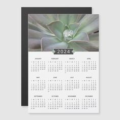 a calendar card with a succulent plant on the front, and a black border around it