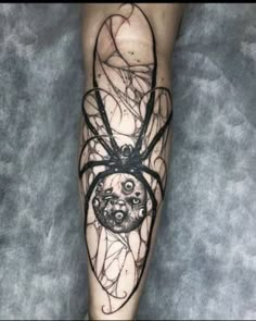 a person with a spider tattoo on their leg