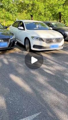 two cars parked in a parking lot next to each other and one is upside down