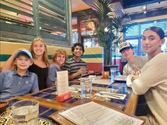 a group of people sitting at a table in a restaurant