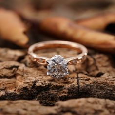 a diamond ring sitting on top of a piece of wood