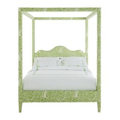 a green and white bed with an ornate headboard on it's side, in front of a white background