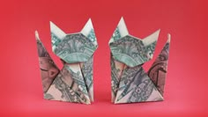 two origami cats made out of money on a red background, one is folded up to look like the other