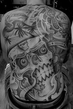 the back of a man with tattoos on his body and head, in black and white