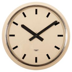 a white clock with black numbers on the face