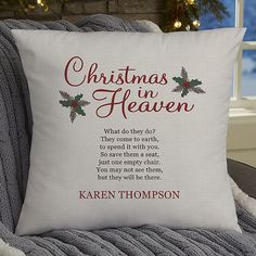 a christmas pillow sitting on top of a couch next to a window with the words christmas in heaven