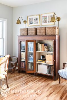 a book case with baskets on top of it