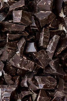 a pile of dark chocolate pieces sitting on top of each other