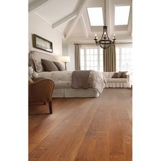 a bedroom with wood floors and white walls