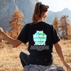 a woman sitting on top of a rock with her hands out