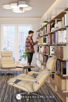 a man standing in front of a bookshelf filled with lots of books and furniture