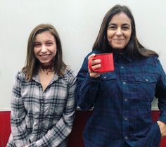 two women standing next to each other holding coffee mugs with blood on their faces