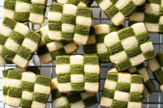 green and white squares are arranged on a wire rack in the shape of cubes