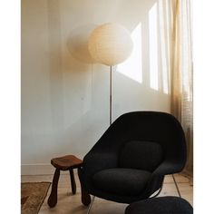 a chair and ottoman in front of a window