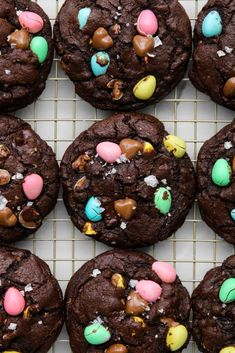 chocolate cookies decorated with candy and m & m's on a cooling rack