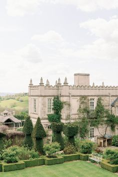 an old building with hedges in front of it