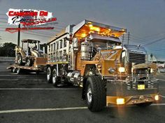 two large trucks parked in a parking lot