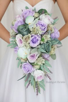 a bride holding a purple and white bouquet