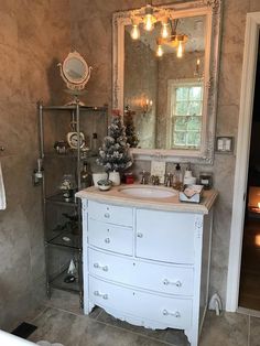 a bathroom with a sink, mirror and bathtub in it's own room