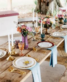 an outdoor table set with plates and place settings