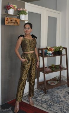 Attractive Banarasi Brocade Trouser with a Blouse Be the lively, beautiful you with an undying spirit as you wear this stylish Banarasi Brocade silk trouser set. This attire has a chic combination of trouser and a blouse with a printed panel detail, which is drool-worthy. Each piece of this outfit is crafted using the excellent quality of material that gives you a stylish and comfortable look. This attractive outfit will shower you compliments for your rich sense of style. This outfit is perfect Festive Sleeveless Pant Set For Party, Elegant Sleeveless Palazzo Set For Festivals, Elegant Sleeveless Palazzo Set For Party, Elegant Sleeveless Navratri Sets, Elegant Sleeveless Palazzo Set For Eid, Fitted Sleeveless Pant Set For Wedding, Sleeveless Fitted Pant Set For Wedding, Festive Sleeveless Palazzo Set For Party Wear, Festive Sleeveless Palazzo Party Wear Set