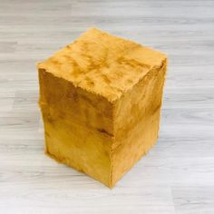 a wooden block sitting on top of a hard wood floor