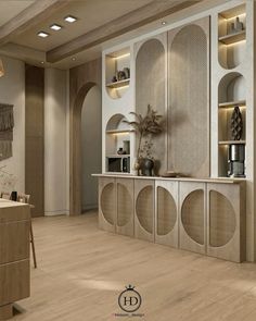 a modern kitchen with wooden floors and white cupboards on the wall, along with built - in shelving