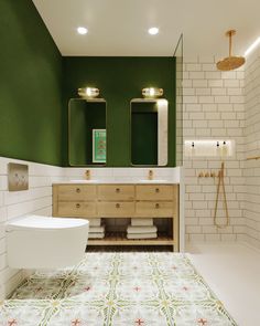 a bathroom with green walls and white tiles on the floor, along with a large bathtub