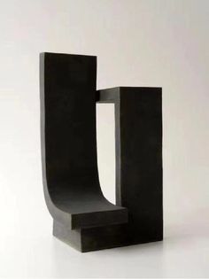 a black sculpture sitting on top of a white floor