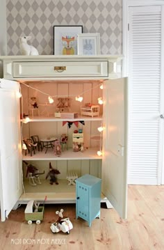 an open cabinet with toys and lights in it