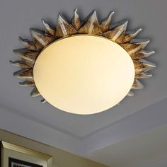 a sunburst light hanging from the ceiling in a living room