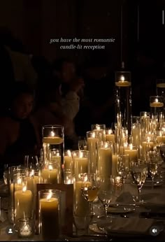 many candles are lit on a table with people in the background and an advertise that reads, you have the most romantic candle - lit reception