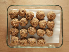 a glass dish filled with cookies on top of a wooden table