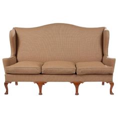 a beige couch sitting on top of a wooden frame