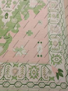 a pink and green area rug with trees on it