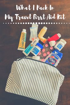 what i pack in my travel first aid kit on top of a wooden table with text overlay that reads, what i pack in my travel first aid kit