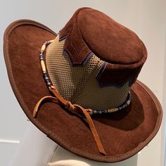 Suede Leather Is Weatherproofed For Durability. Water Will Roll Right Off It. Breathable And Lightweight With Mesh Crown Unisex Hat- Brim: 2-¾” Crown: 3-¾” Made To Fit Any Head Size 6 7/8 Through 8 1/8", Fits Round And Oval Heads Rustic Style Is Perfected In This Extremely Limited Edition Hat. The Sierra Nevada Leather Cowboy Hat Features A Classic, Bold Brown Suede Leather Complemented With A Vintage Buckskin Suede Contrasting The Underside Of The Brim In Cobalt Blue Suede. Brown Leather Wide Brim Hat, Brown Leather Travel Hat, Casual Brown Leather Hat, Adjustable Brown Sun Hat For Country Events, Casual Brown Sun Hat For Rodeo, Brimmed Brown Hats, One Size, Country Style Brown Sun Hat With Curved Brim, Country Style Brown Sun Hat For Outdoors, Casual Brown Hat Bands For Rodeo